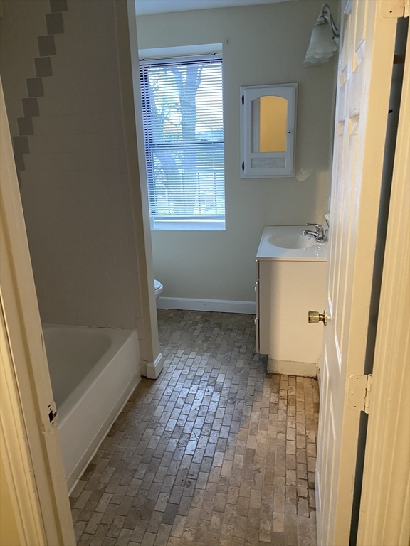 96 Marcella Street, Unit 2 Boston, MA 02119 - Photo 29 of 37 a bathroom with a sink and a shower