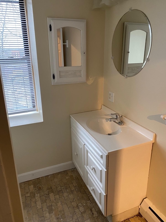 96 Marcella Street, Unit 2 Boston, MA 02119 - Photo 31 of 37 a utility room with a sink a vanity and a mirror