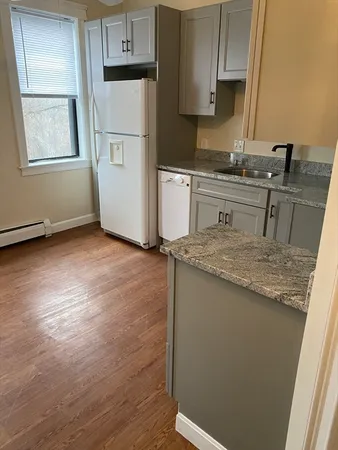a kitchen with a sink a stove a refrigerator and cabinets