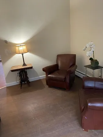 a living room with furniture and a lamp