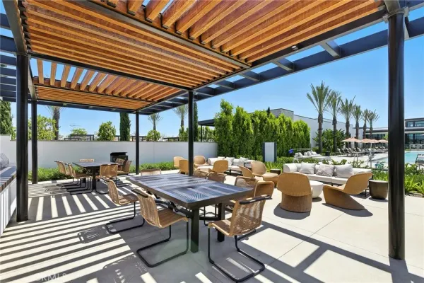 a view of a patio with table and chairs and potted plants
