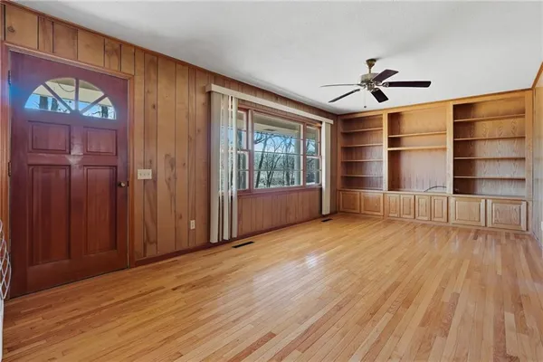 wooden floor in an empty room with a window