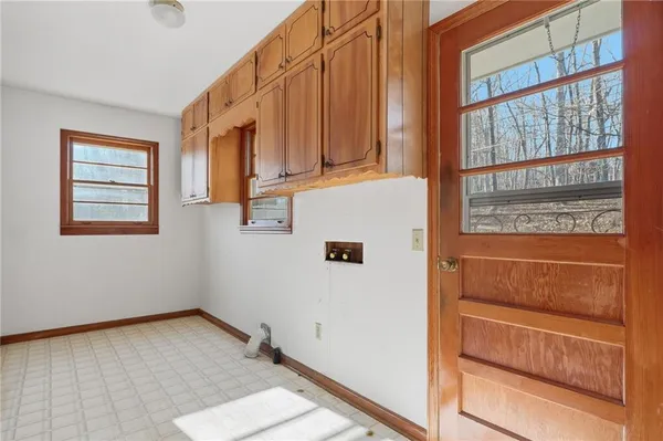 a bathroom with a granite countertop toilet a sink and a window