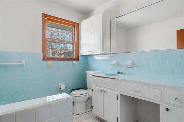 a bathroom with a sink a toilet and bathtub