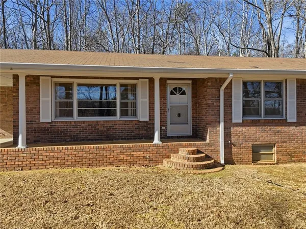 front view of a brick house with a large window