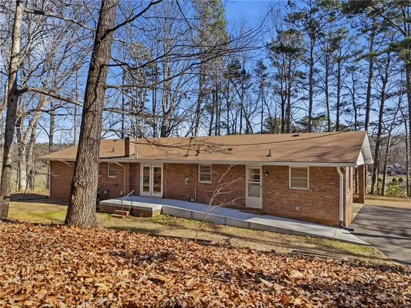 a view of a house with large trees