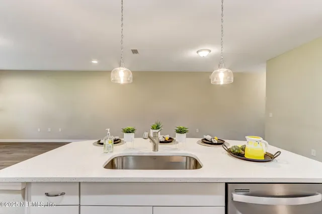 a bathroom with a double vanity sink mirror and shower