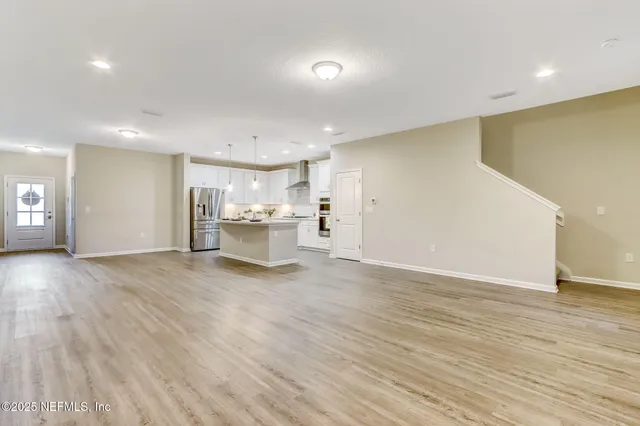 a bathroom with a sink a mirror and a potted plant
