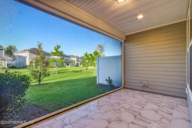 a front view of a residential apartment building with a yard