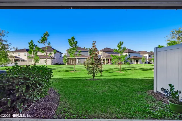 a view of a swimming pool with lawn chairs under an umbrella