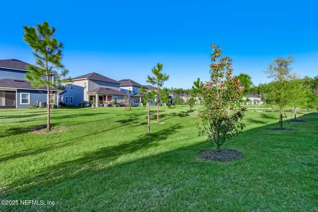 a dining room with furniture and a floor to ceiling window