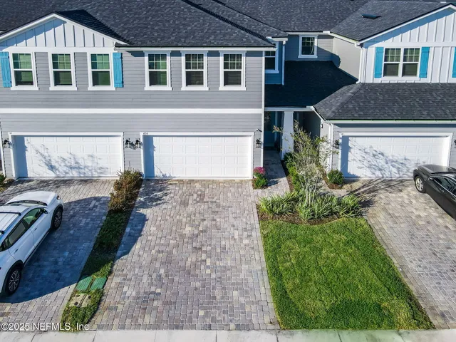 a living room with furniture a dining table and a fireplace