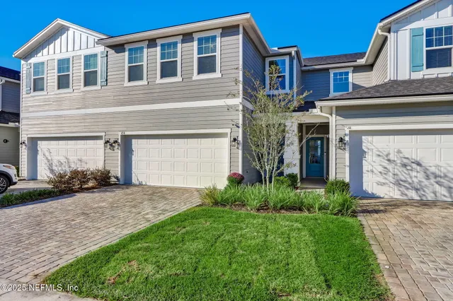 a kitchen with a sink a stove and chairs