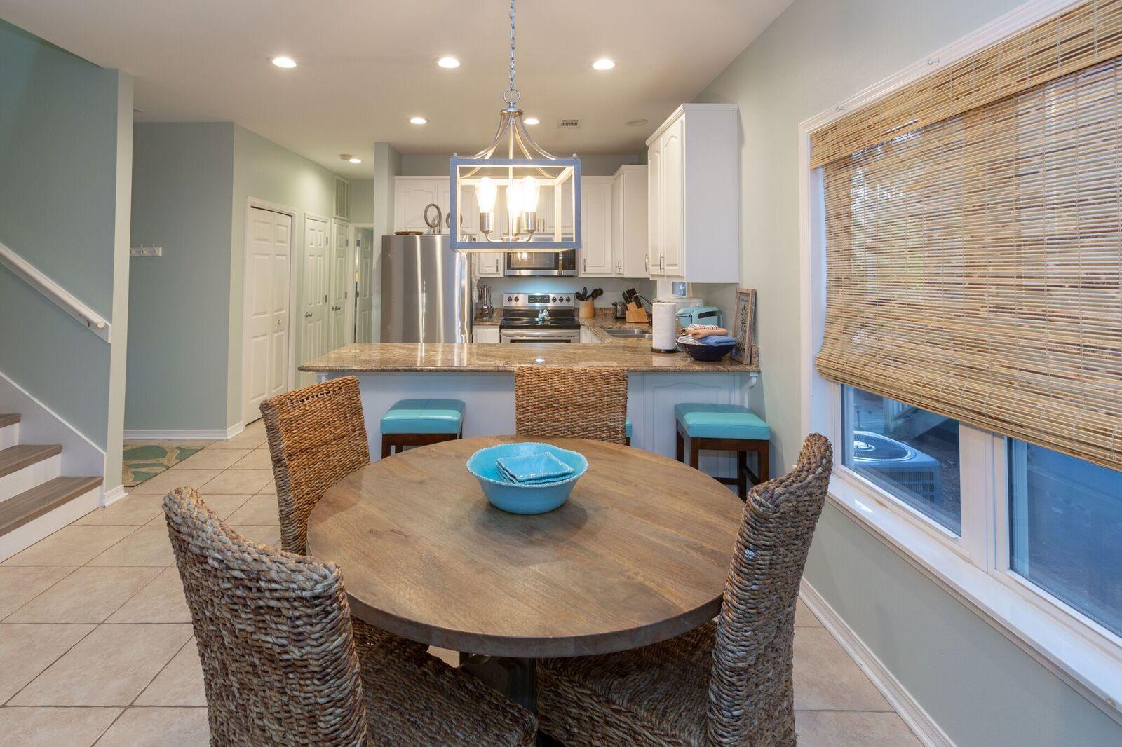 474 Hidden Lake Way Santa Rosa Beach, FL 32459 - Photo 5 of 34 a kitchen with stainless steel appliances granite countertop a dining table chairs and a living room view