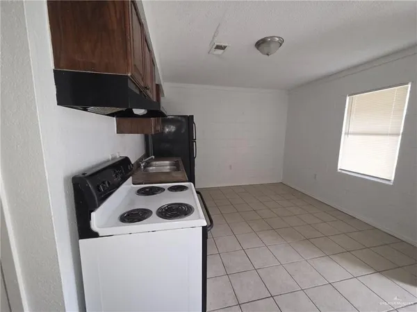 a kitchen with a stove and a microwave