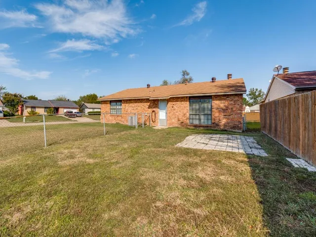 a view of a house with a yard and sitting area