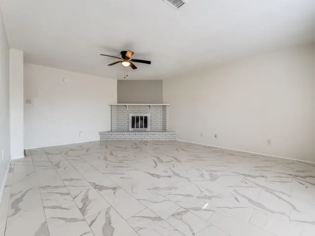 a view of empty room with ceiling fan