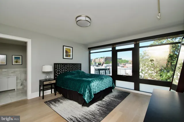 a bedroom with a large bed and a large window