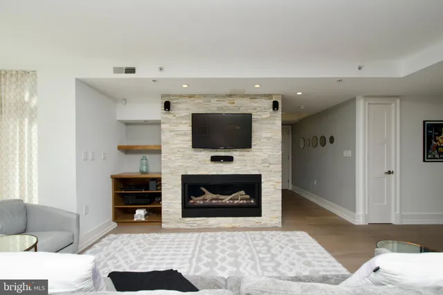 a living room with furniture and a fireplace