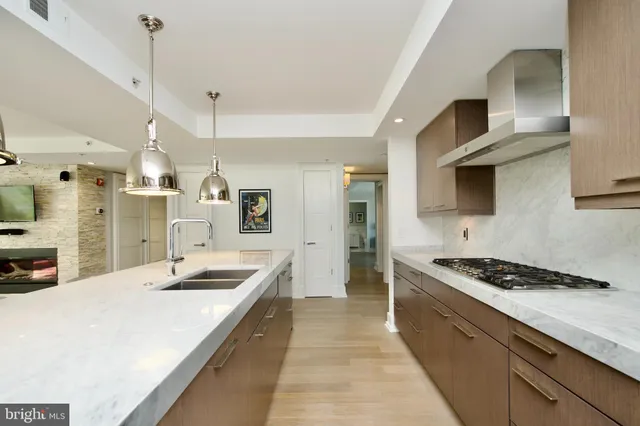 a kitchen with stainless steel appliances kitchen island a sink and cabinets