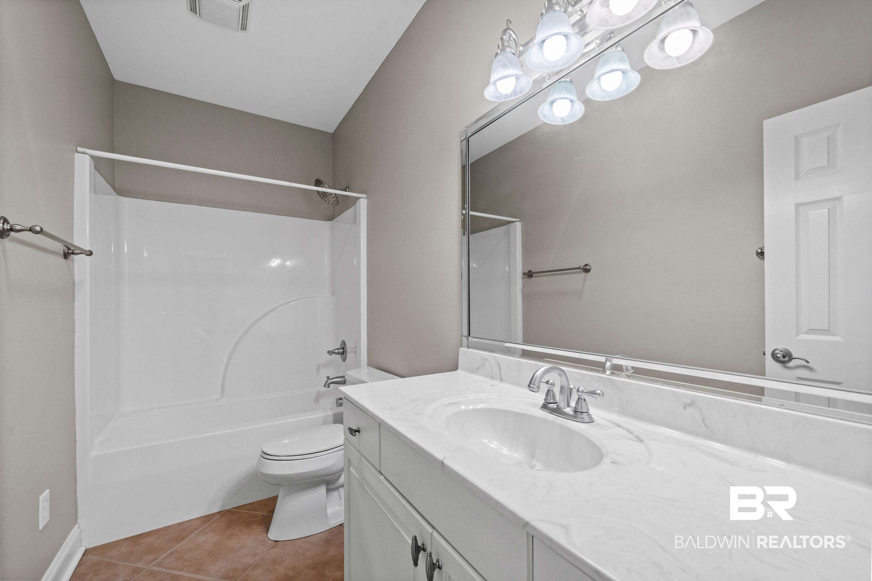 303 Savannah Circle Foley, AL 36535 - Photo 17 of 34 Bathroom featuring a white vanity with a single basin, a chrome faucet, and a large mirror