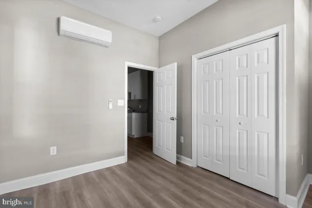 a view of an empty room and wooden floor