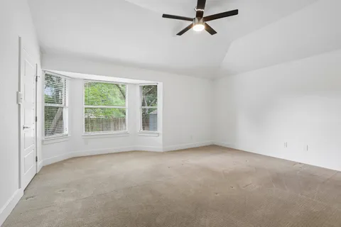 an empty room with a empty space and windows