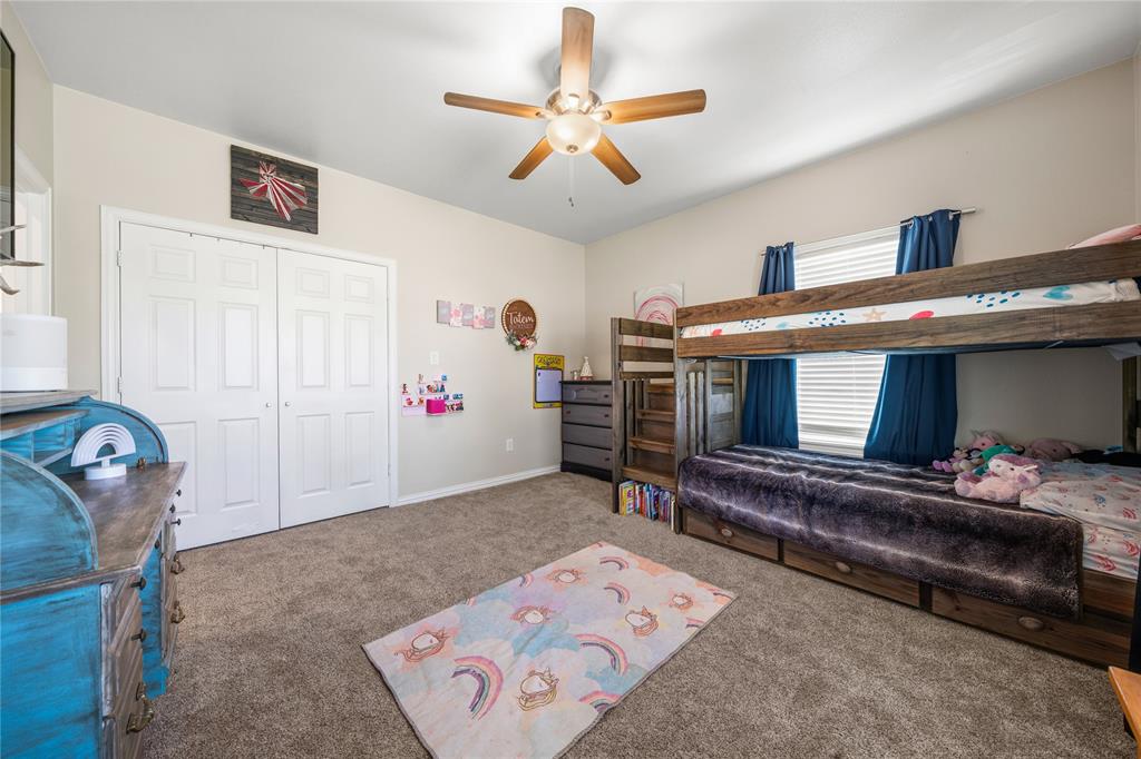 105 South 6th Street Celeste, TX 75423 - Photo 14 of 34 a bedroom with furniture and a chandelier