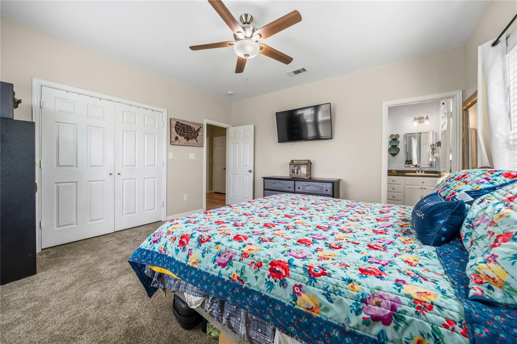 105 South 6th Street Celeste, TX 75423 - Photo 15 of 34 a bedroom that has a bed and a tv in it