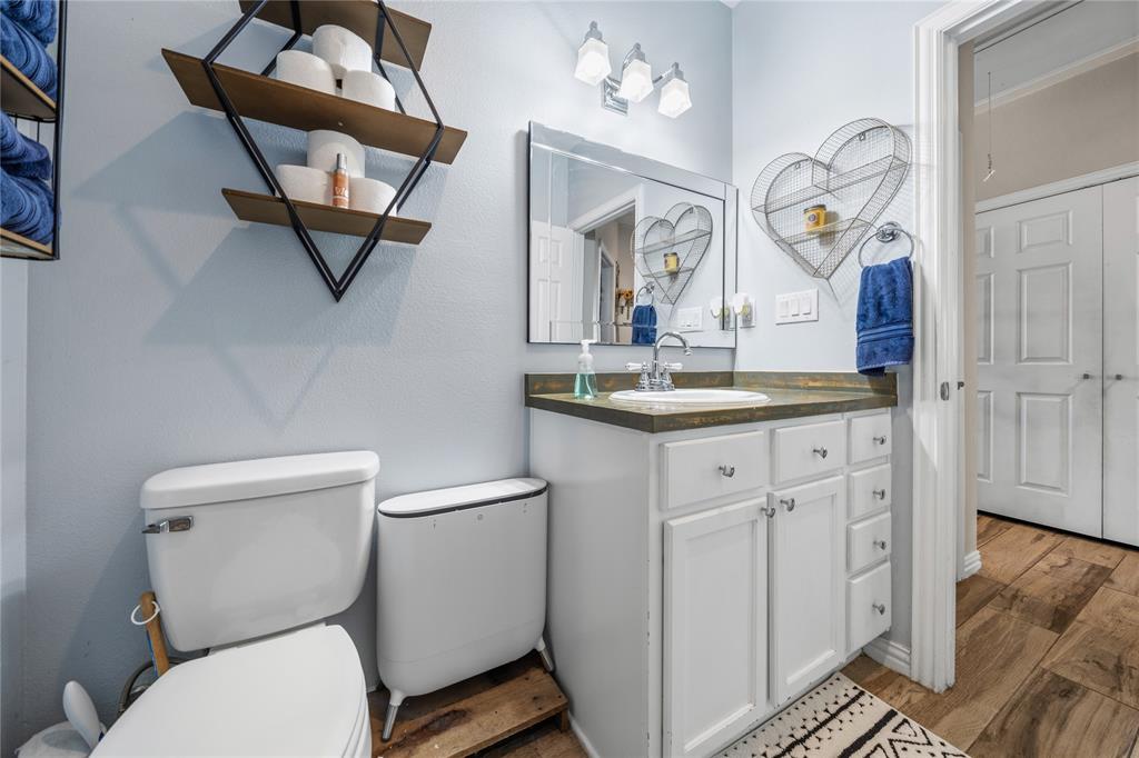 105 South 6th Street Celeste, TX 75423 - Photo 18 of 34 a bathroom with a toilet a sink and mirror
