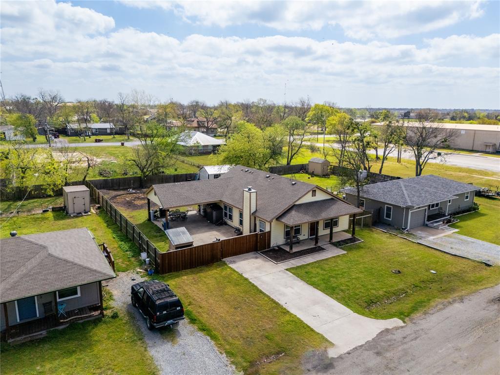 105 South 6th Street Celeste, TX 75423 - Photo 31 of 34 a view of a swimming pool and lounge chairs in back of a house