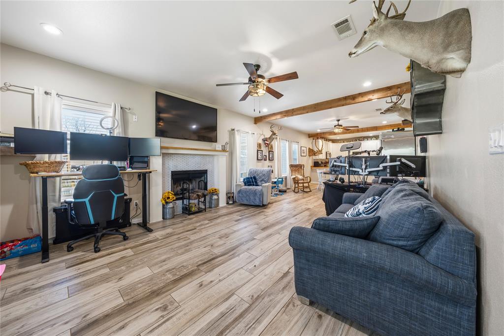 105 South 6th Street Celeste, TX 75423 - Photo 4 of 34 a living room with furniture a flat screen tv and a fireplace