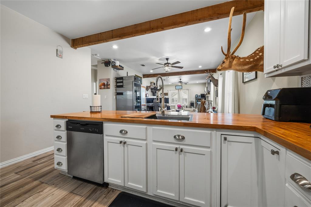105 South 6th Street Celeste, TX 75423 - Photo 8 of 34 a kitchen with white cabinets and sink