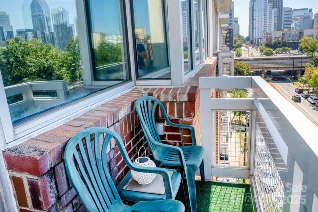 a balcony with furniture and a potted plant