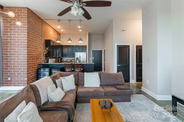 a living room with furniture and a chandelier