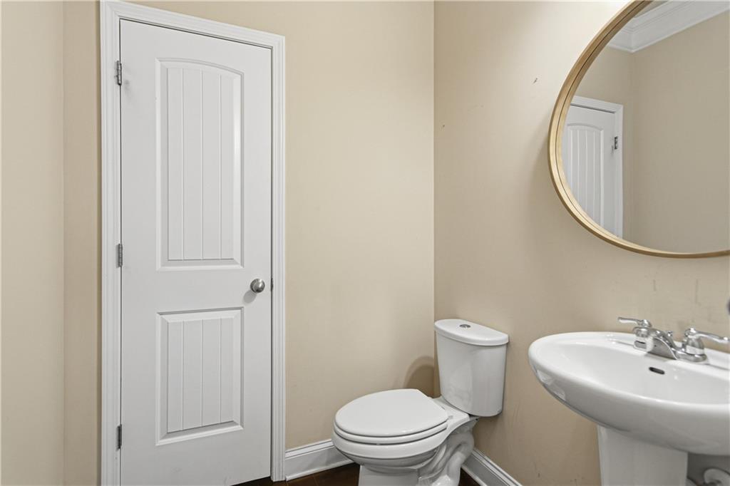 114 Madison Street Canton, GA 30115 - Photo 27 of 39 a bathroom with a sink a toilet and a mirror