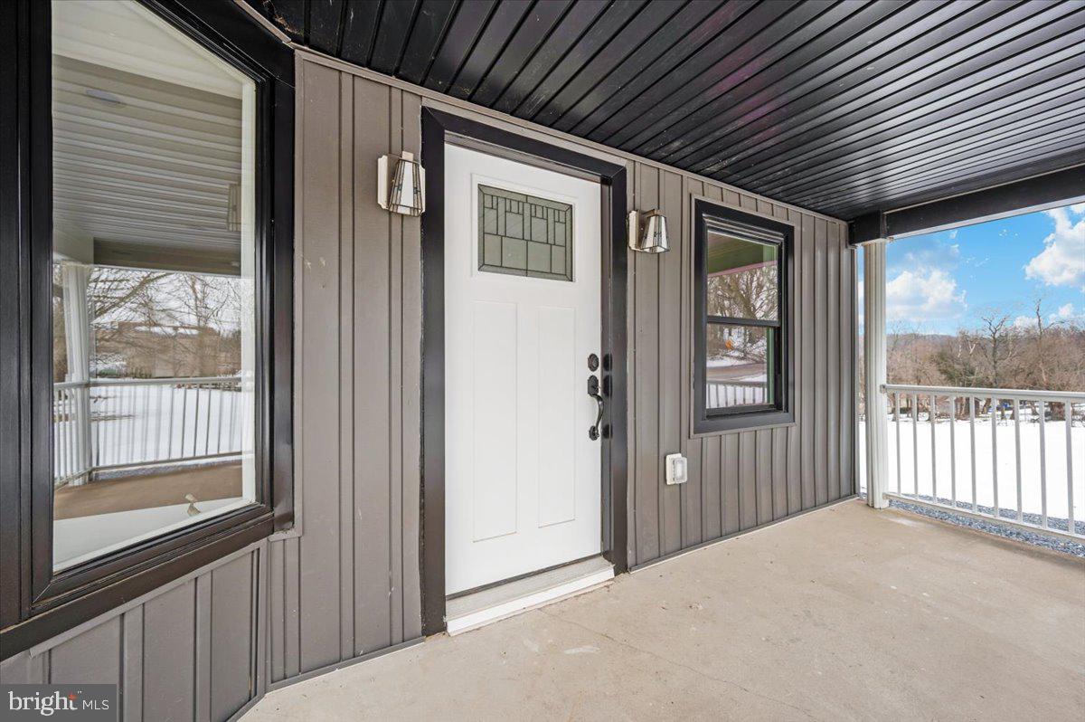 9932 Kelly Road Frederick, MD 21701 - Photo 2 of 74 a view of a porch with wooden floor and a backyard space