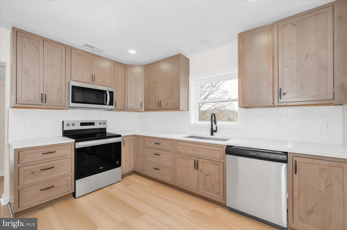 9932 Kelly Road Frederick, MD 21701 - Photo 24 of 74 a kitchen with appliances cabinets and a sink