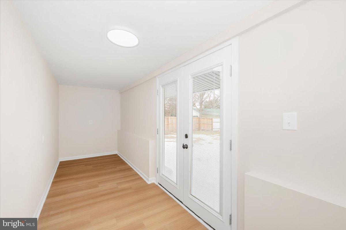 9932 Kelly Road Frederick, MD 21701 - Photo 27 of 74 a view of a room with wooden floor and white walls