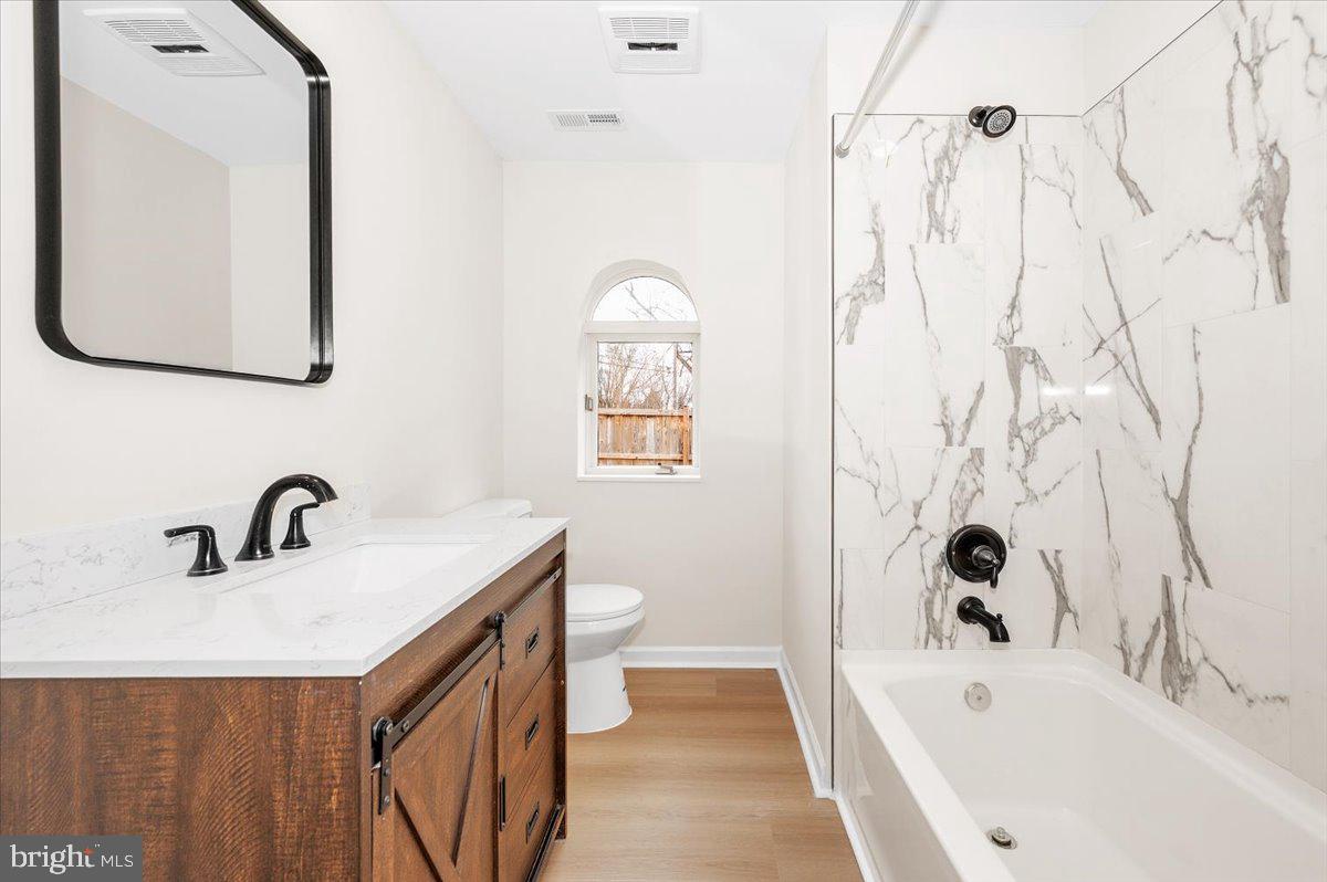 9932 Kelly Road Frederick, MD 21701 - Photo 34 of 74 a bathroom with a tub sink and mirror