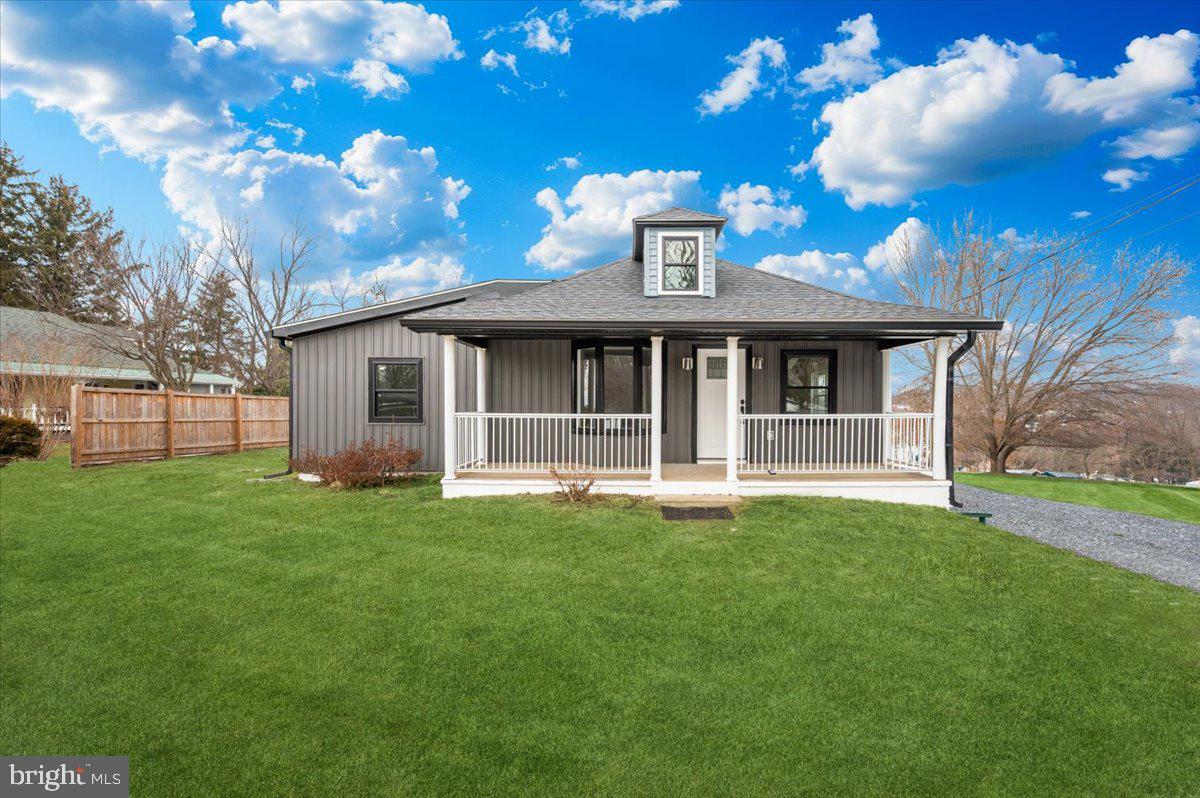 9932 Kelly Road Frederick, MD 21701 - Photo 4 of 74 a view of a white house with a big yard and large trees