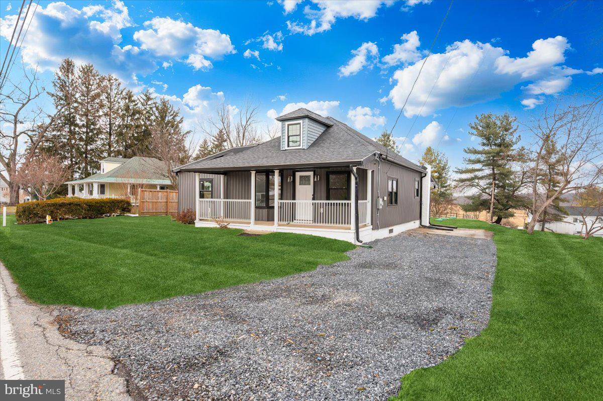 9932 Kelly Road Frederick, MD 21701 - Photo 10 of 74 a view of a brick house next to a yard with big trees