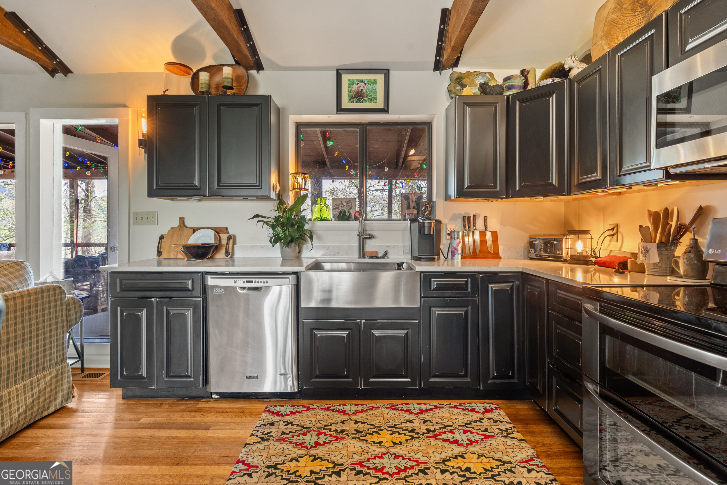 426 Crow Creek Road Lakemont, GA 30552 - Photo 13 of 60 a kitchen with stainless steel appliances wooden cabinets and a counter top space