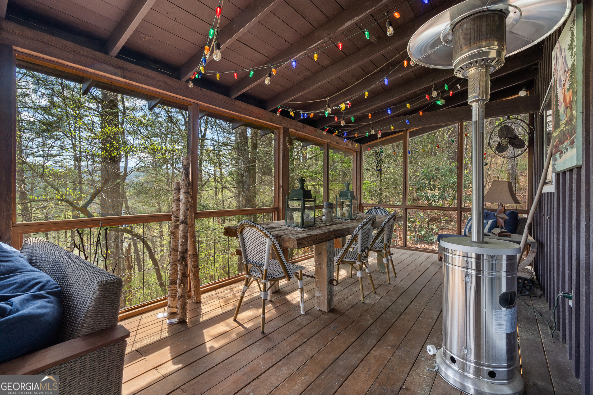 426 Crow Creek Road Lakemont, GA 30552 - Photo 16 of 60 a view of a porch with furniture and wooden floors