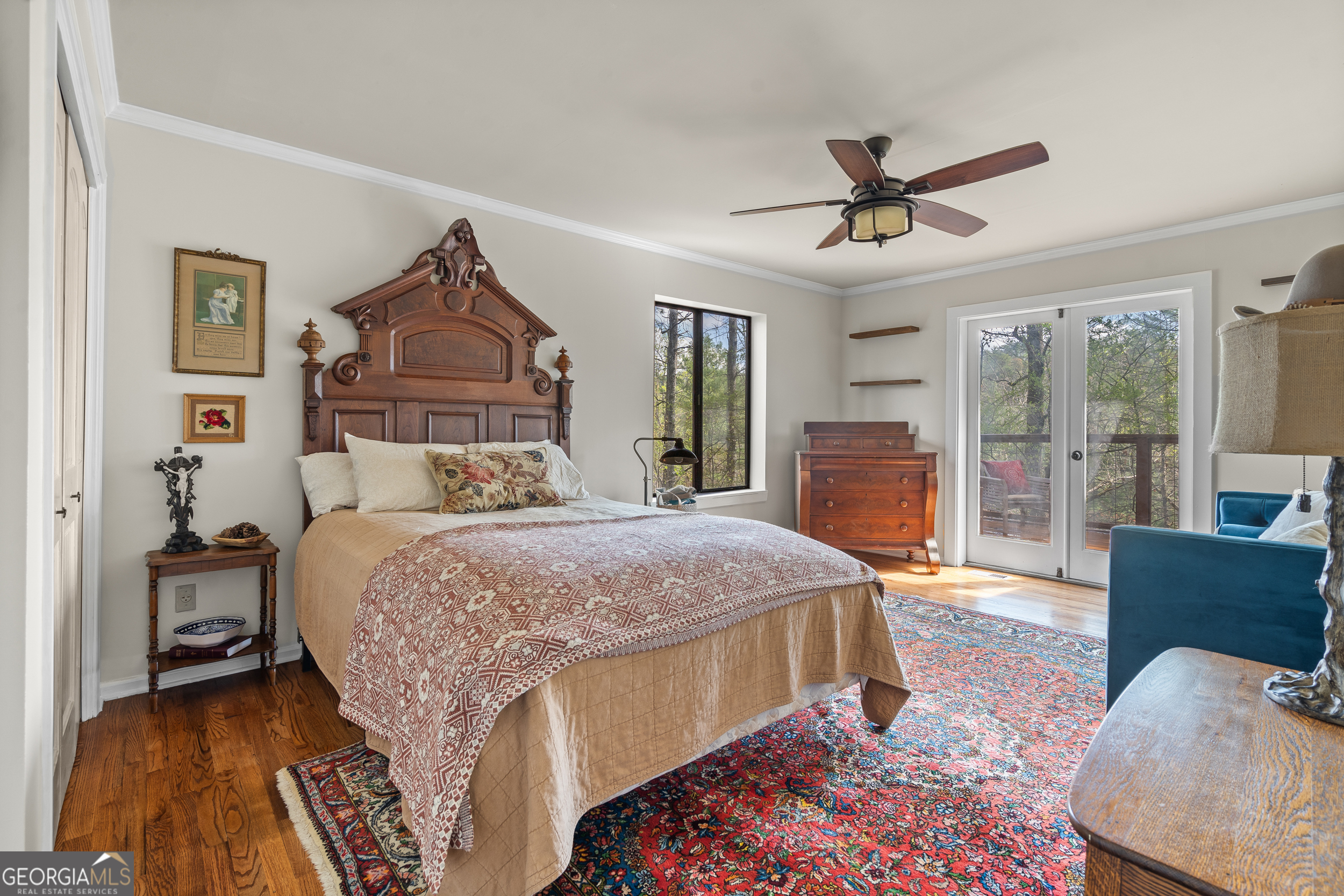 426 Crow Creek Road Lakemont, GA 30552 - Photo 21 of 60 a bedroom with a large bed a chandelier and dresser