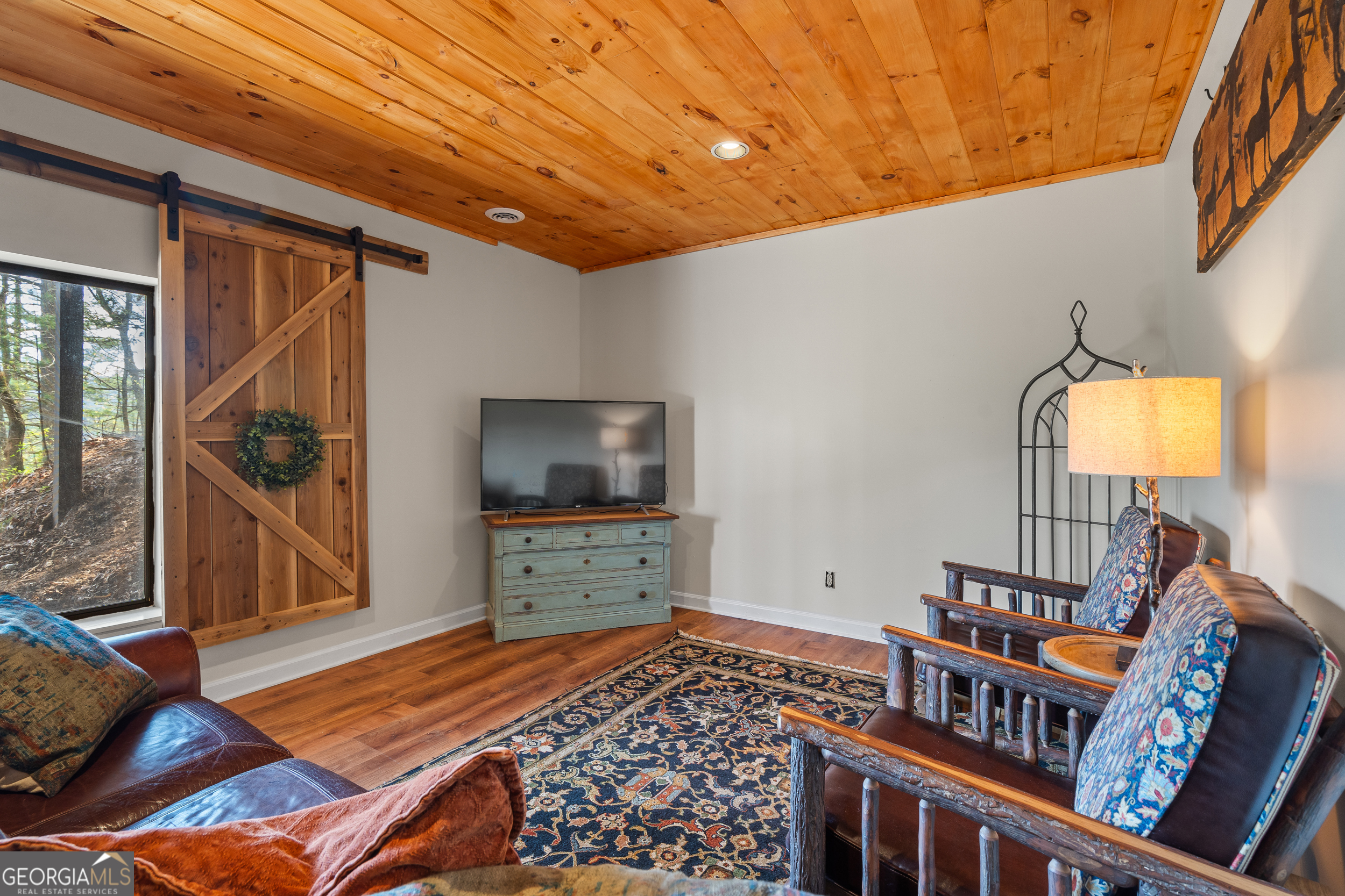 426 Crow Creek Road Lakemont, GA 30552 - Photo 33 of 60 a bedroom with furniture and a flat screen tv