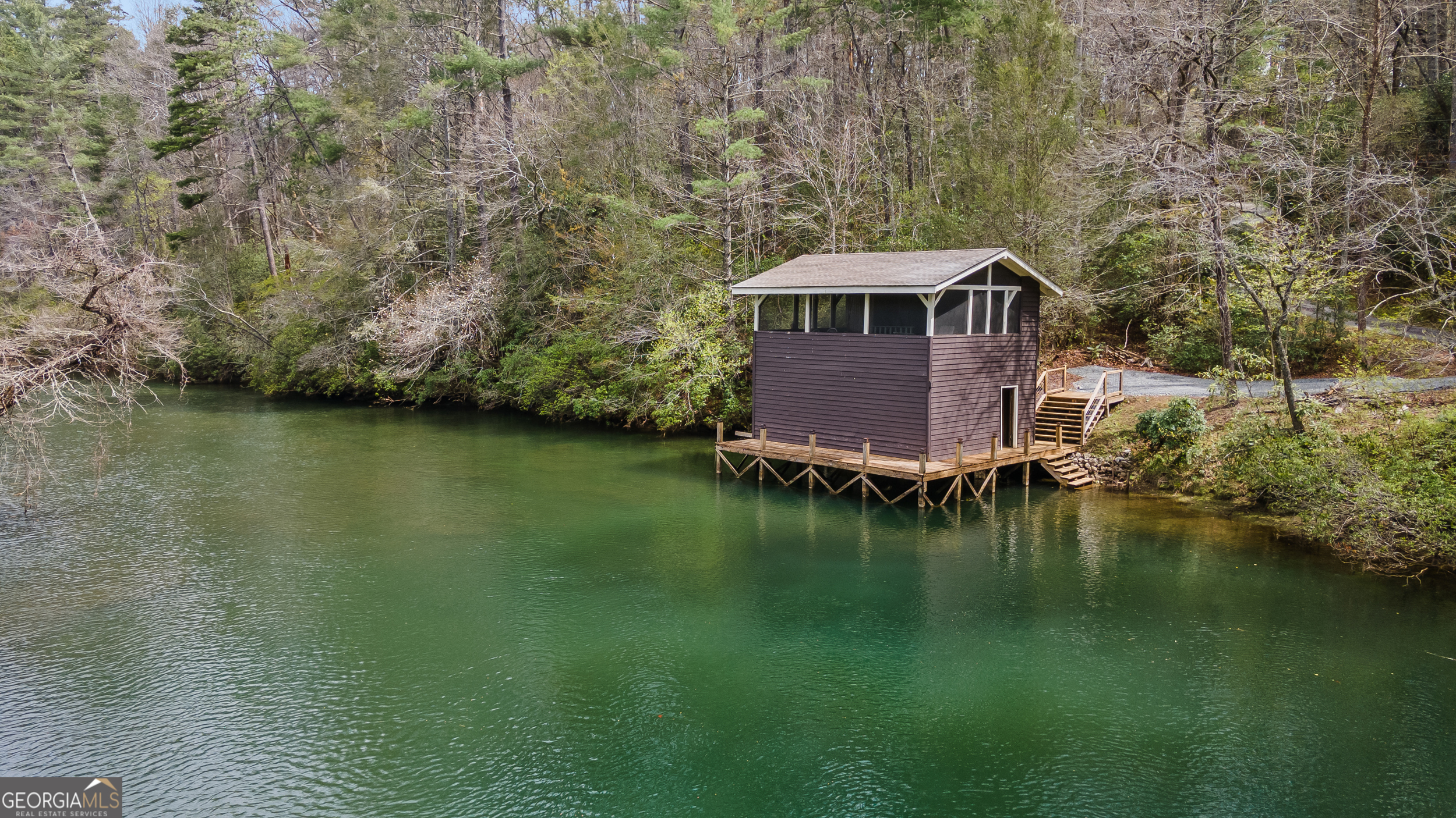 426 Crow Creek Road Lakemont, GA 30552 - Photo 53 of 60 a view of a lake with a yard and mountain view