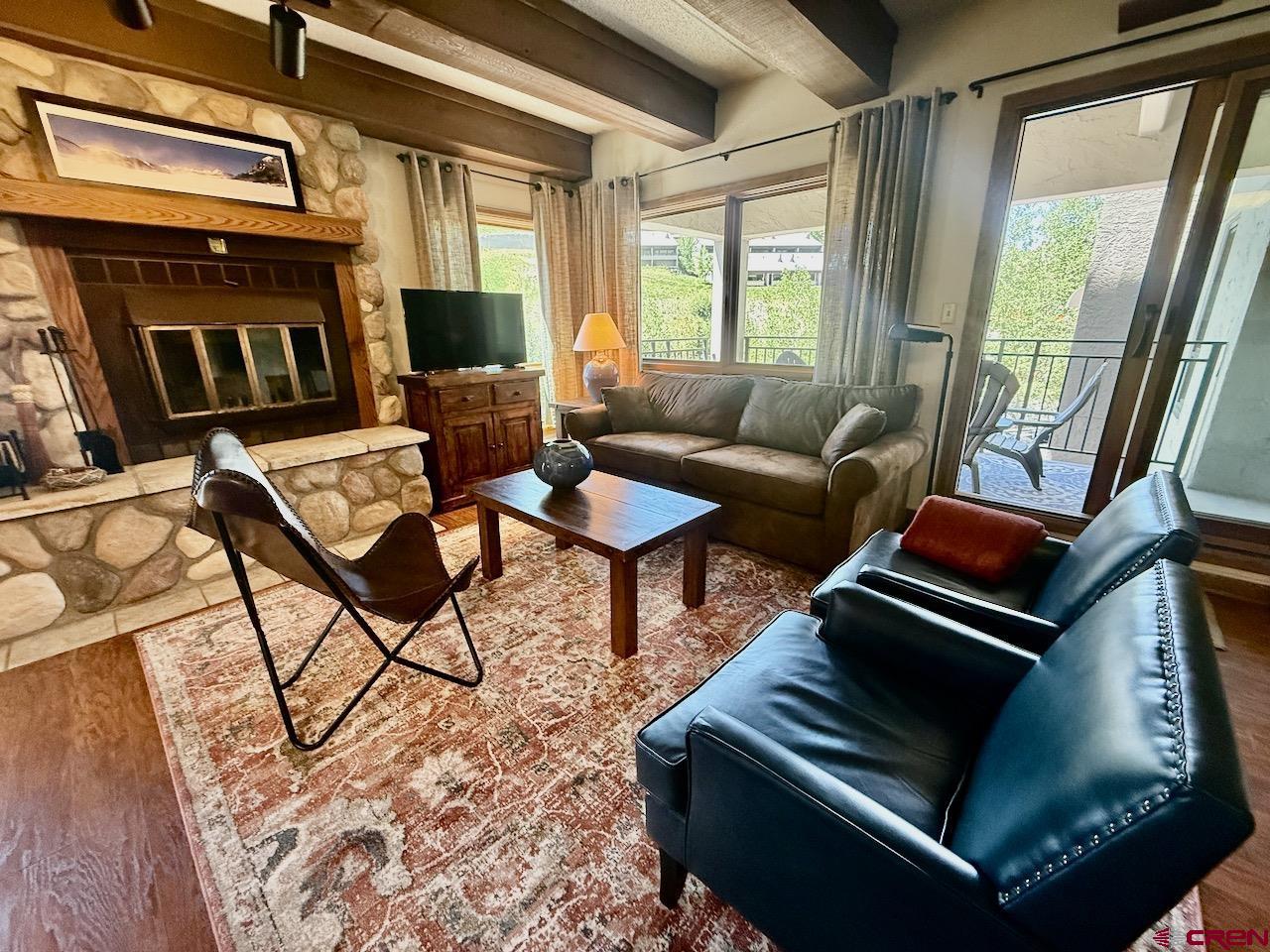 11 Snowmass Road, Unit 337 Crested Butte, CO 81225 - Photo 6 of 35 a living room with furniture and a fireplace
