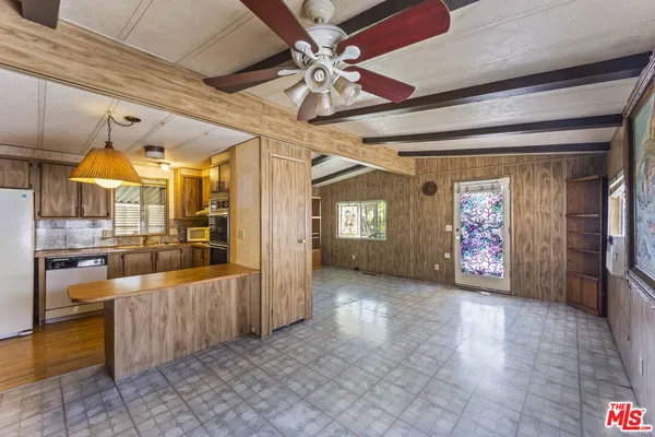 a kitchen with stainless steel appliances granite countertop a refrigerator and a stove