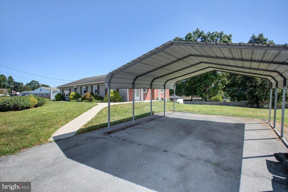 238 Sollenberger Road Chambersburg, PA 17202 - Photo 49 of 64 Spacious carport with lush green surroundings.